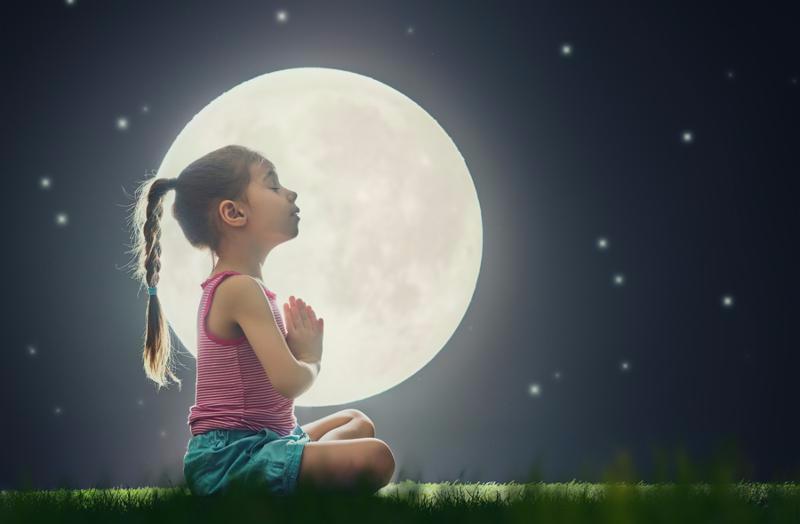cute little child girl enjoying meditation and yoga on green grass on moon sky (1)